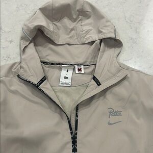 Patta x Nike collab on tan running jacket with hood. Size XL. Oversized. EUC